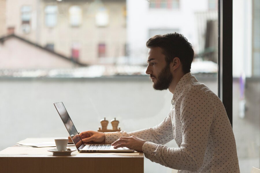 Man applying for an instant loan online using laptop – quick approval process in 2025